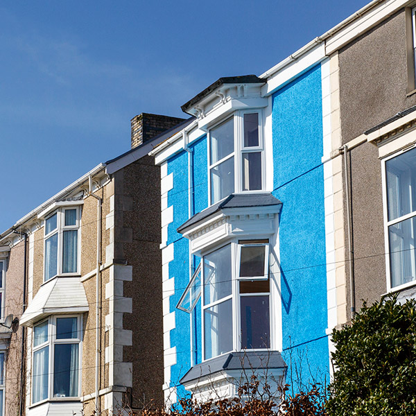 Image of two teracced houses, one blue and one brown