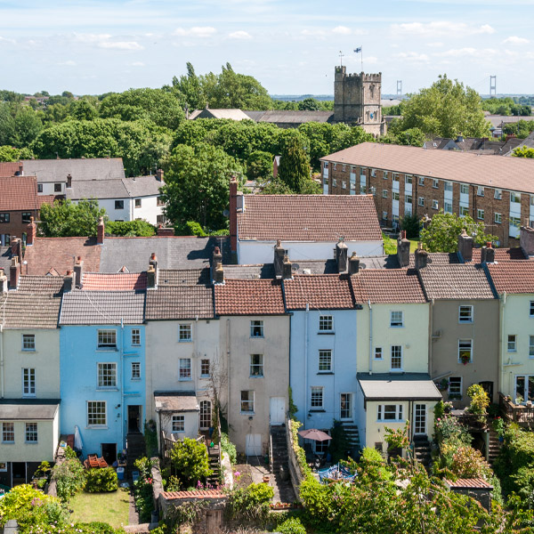 Aerial view of terraced houses with a church in the background