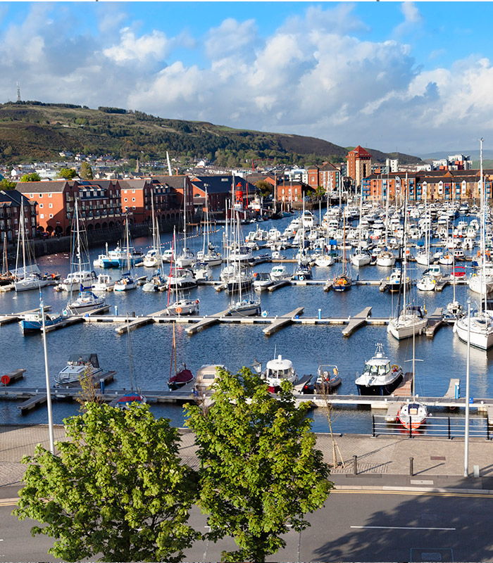 Shot of a harbour looking out into the water, with buildings to the left
